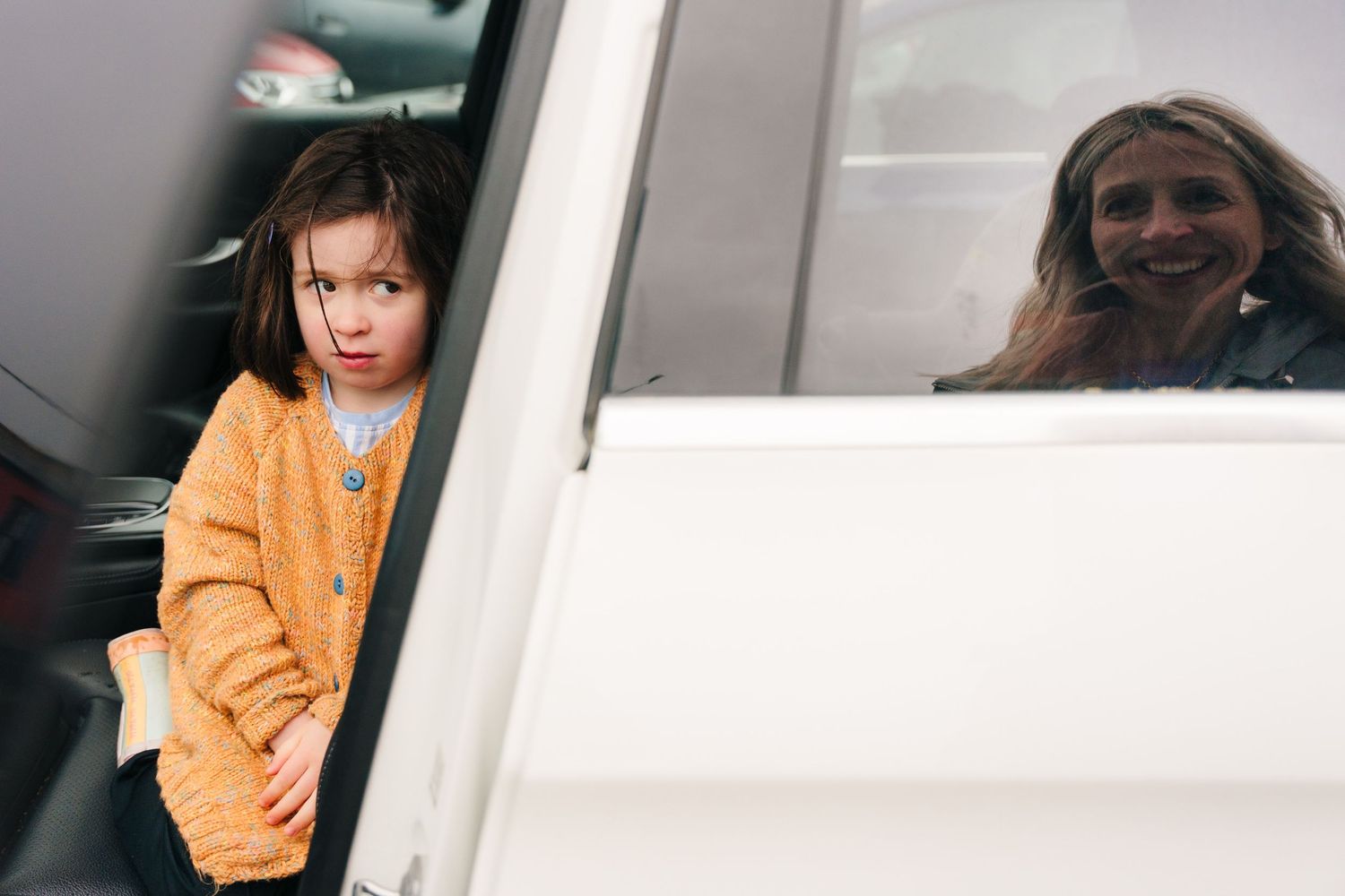 Camera captures people in a vehicle, with an orange sweater visible through the window. PHOTOGRAPHER Dublin
