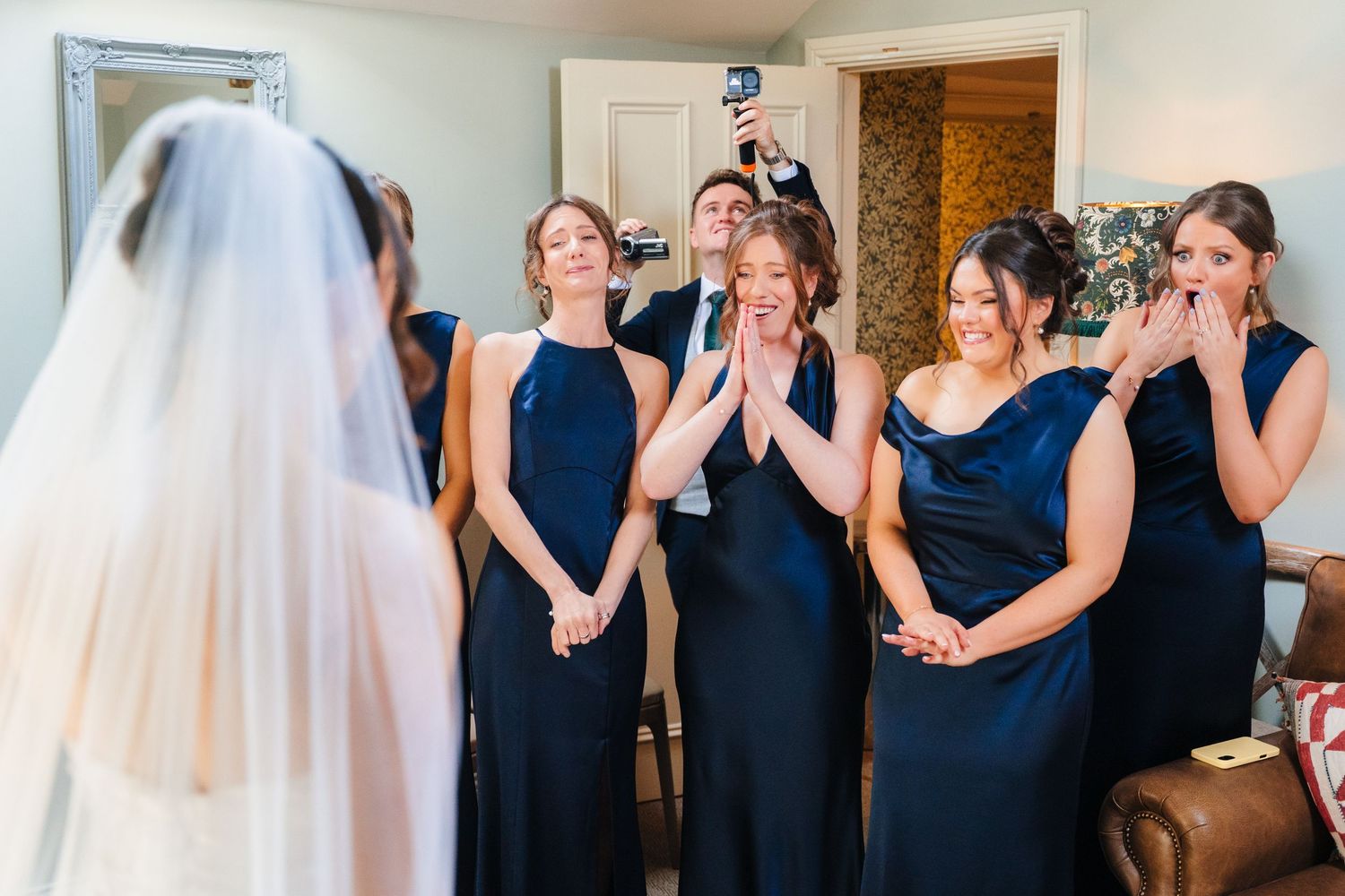 Virginia Park Lodge Wedding photographer Dublin Bridesmaids in navy blue dresses react emotionally to seeing the bride for the first time.