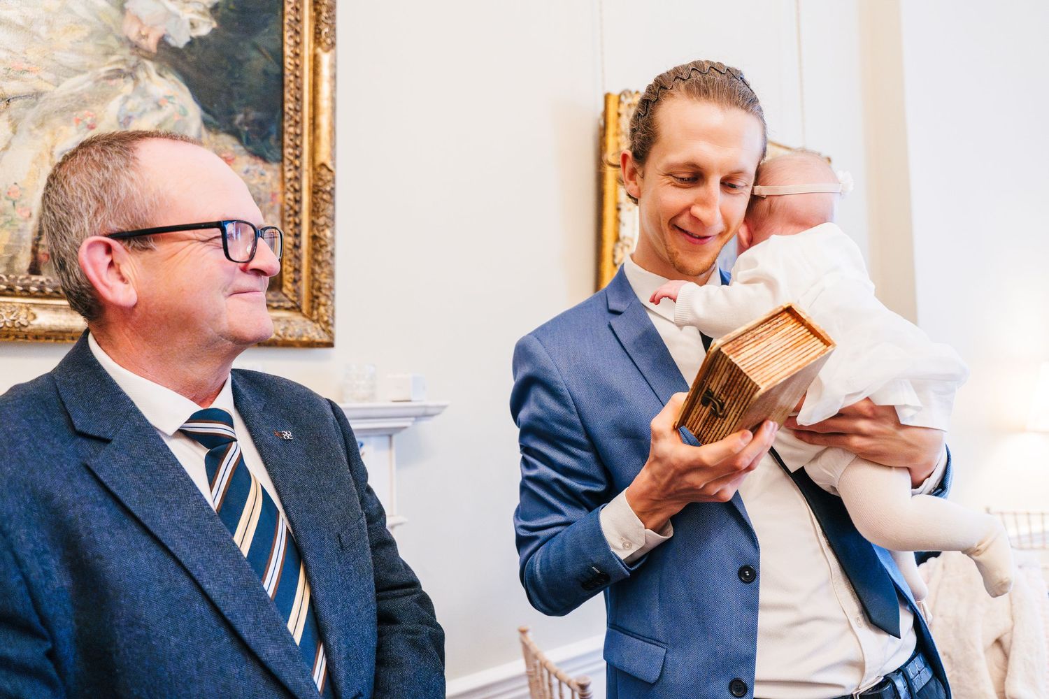 Wedding guests in formal suits share laughter and conversation at an elegant event.  Wedding PHOTOGRAPHER Dublin