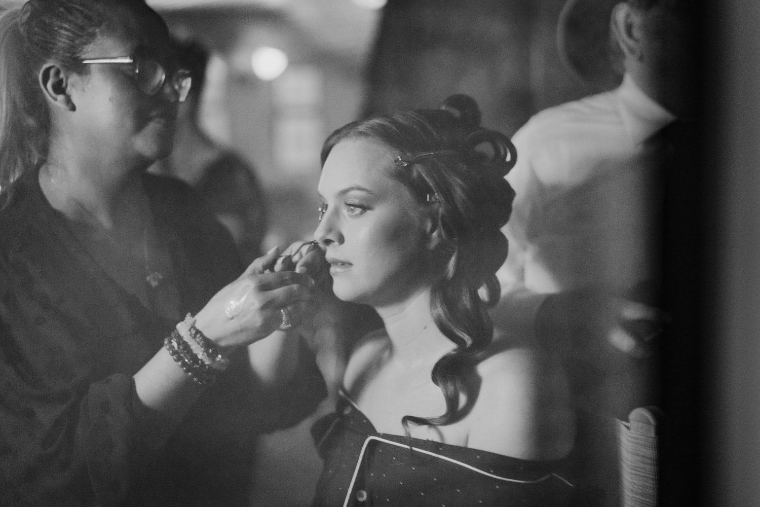 Poulaphouca Wedding photographer wicklow  ]Black and white photo of makeup application during wedding preparations.