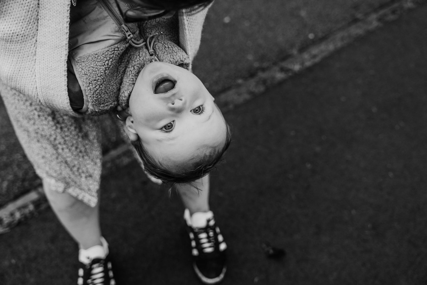 Family photographer Dublin Ireland  Black and white upside-down portrait showing pure joy and playfulness.
