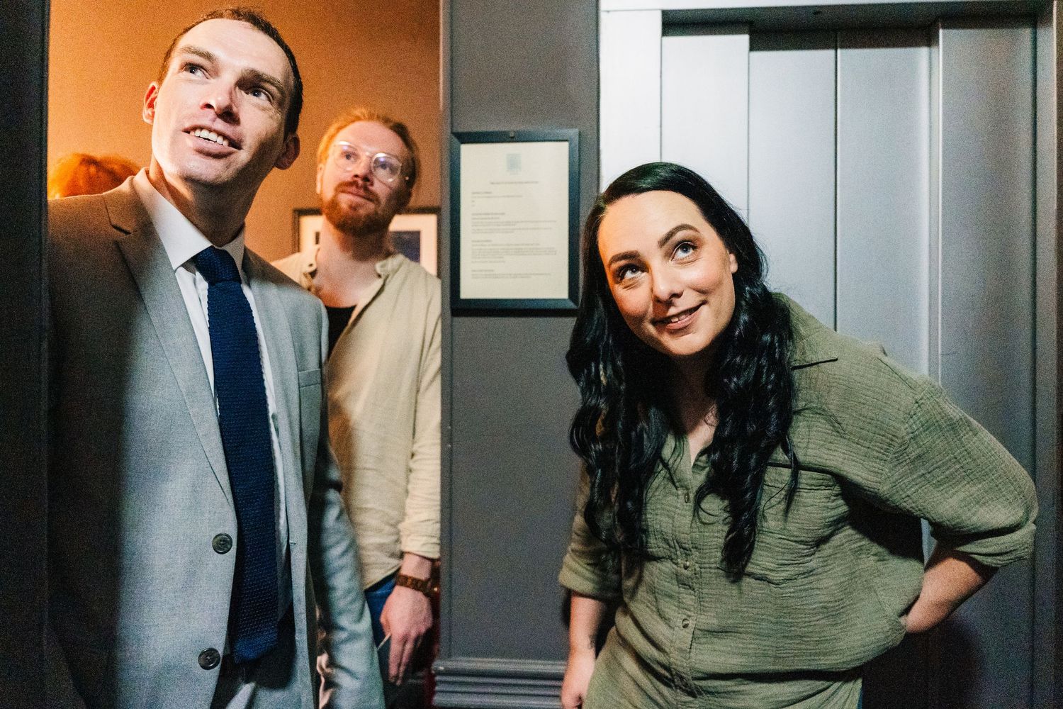 Three professionals smiling and posing together in an office hallway setting. House Dublin Wedding Photographer