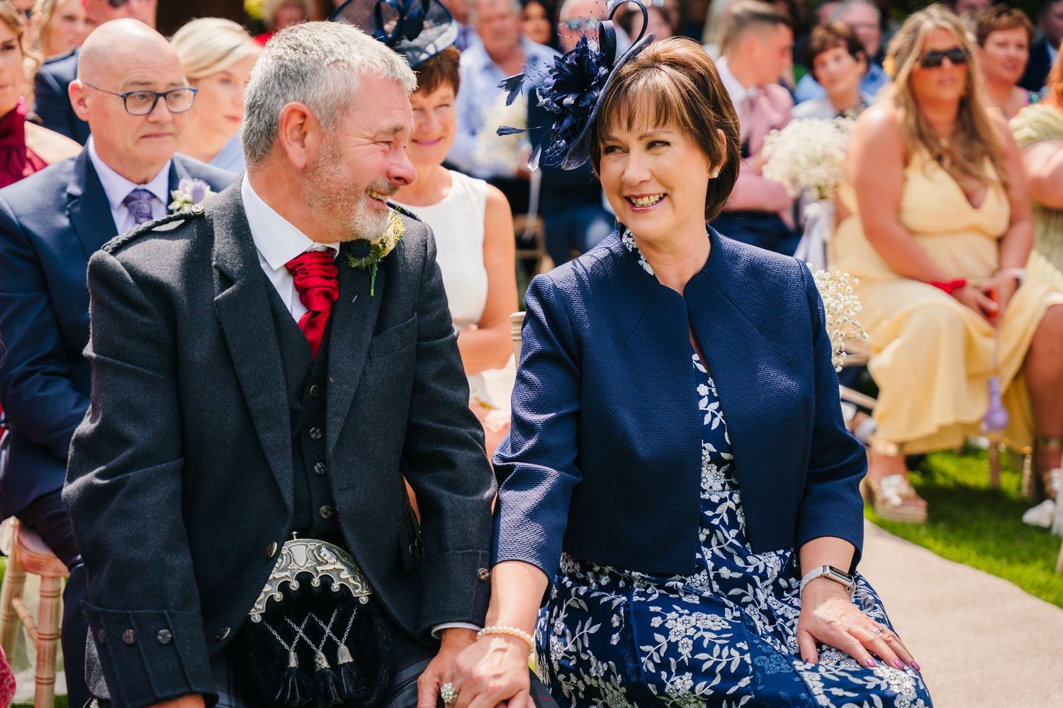 Wedding guests enjoying an outdoor celebration on a sunny day. Portmarnock Hotel Wedding PHOTOGRAPHER Dublin