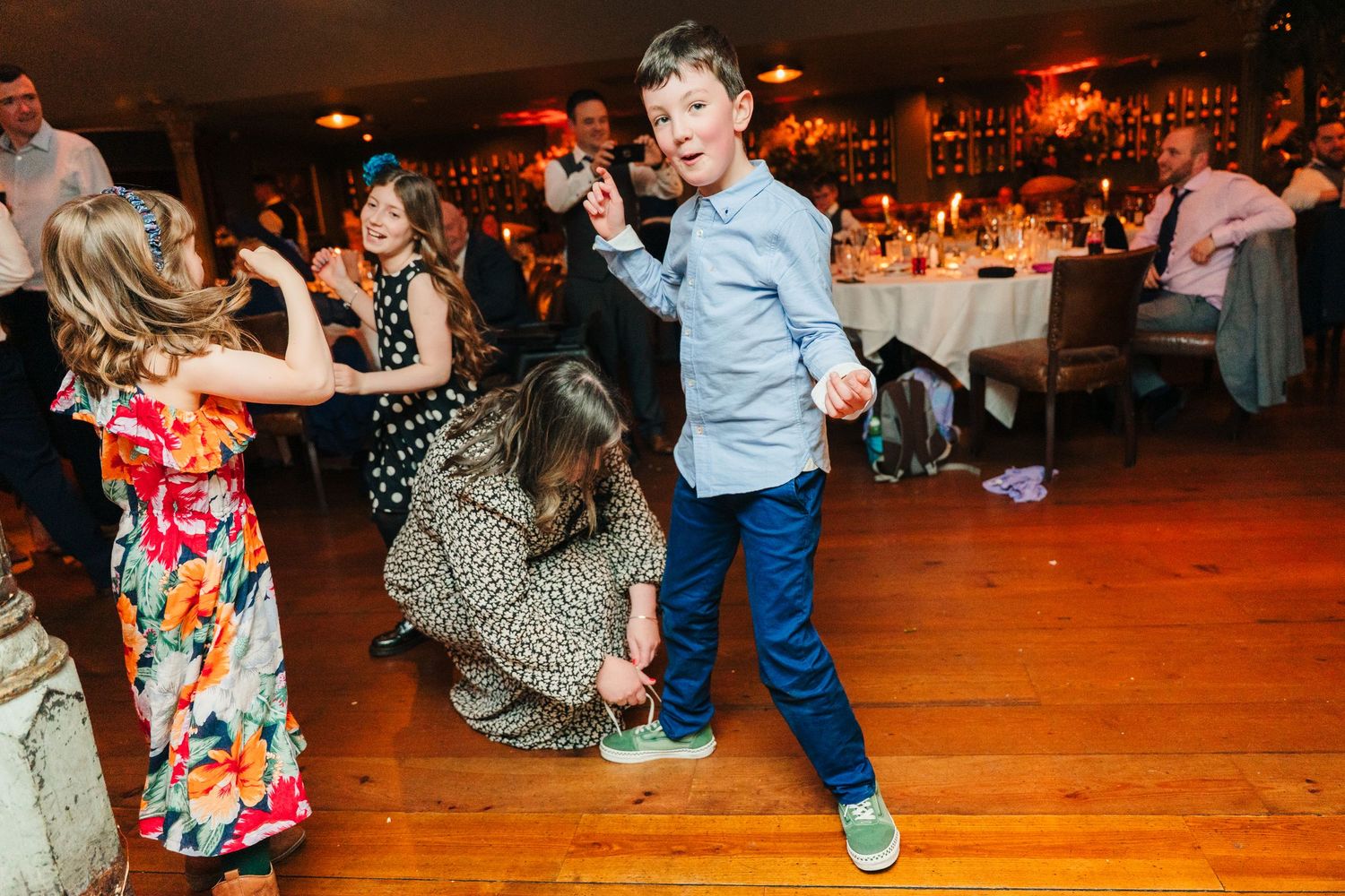 Wedding guests dance enthusiastically on a wooden dance floor at an energetic reception celebration. Marco Pierre Dublin Wedding Photographe