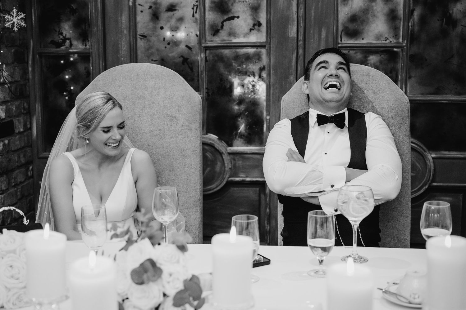 A sequence of black and white wedding reception photos showing guests laughing and enjoying speeches at dinner. Dublin Wedding photographer