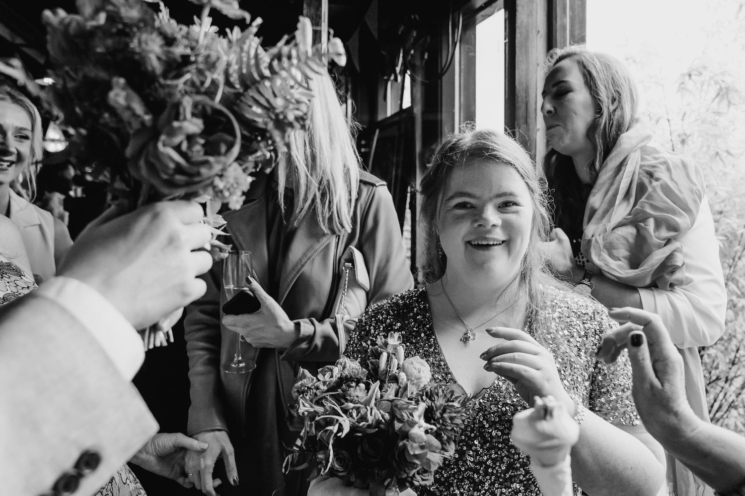 Black and white candid shots capture laughter and celebration at a wedding reception. Wedding photographer Dublin