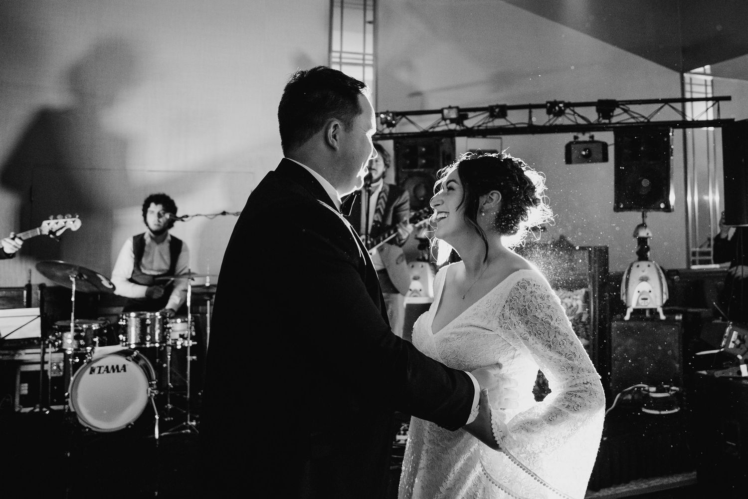 Silhouettes of wedding couple and band performing on stage with dramatic lighting.Wedding Photography Trim Castle Ireland