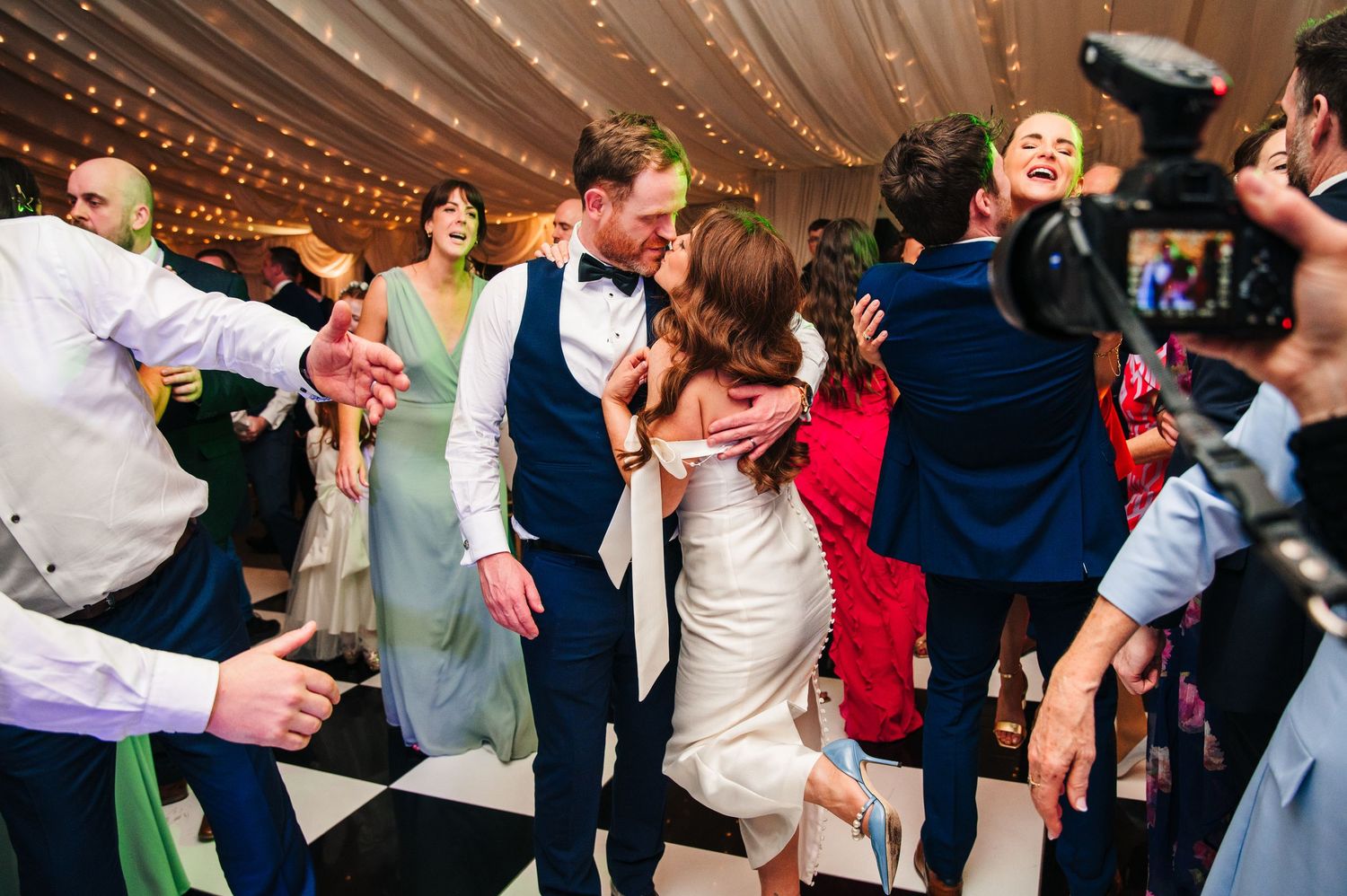 Castle Leslie Wedding Photographer Dublin Wedding guests dancing energetically on a crowded reception dance floor.