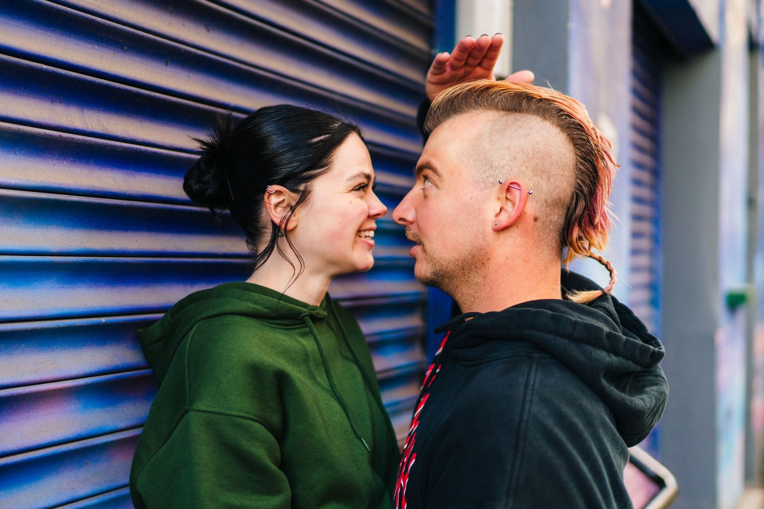 Two people share an intimate moment against a blue industrial door. PHOTOGRAPHER Dublin Ireland