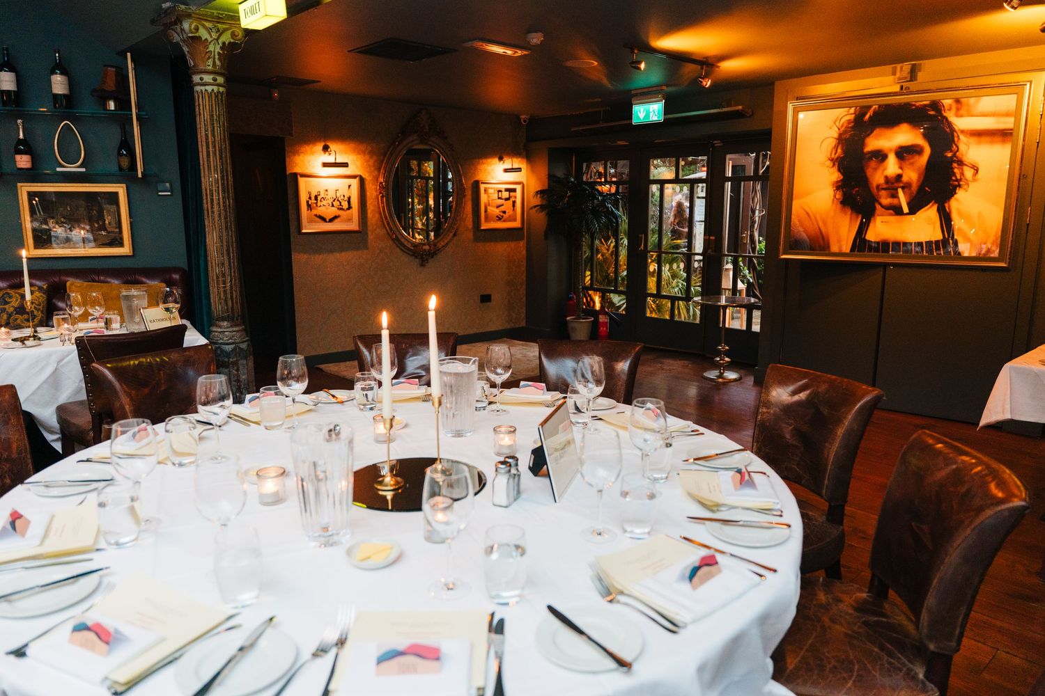 Wedding reception venue with white tablecloths and elegant table settings in a dimly lit restaurant atmosphere. Marco Pierre Dublin Wedding