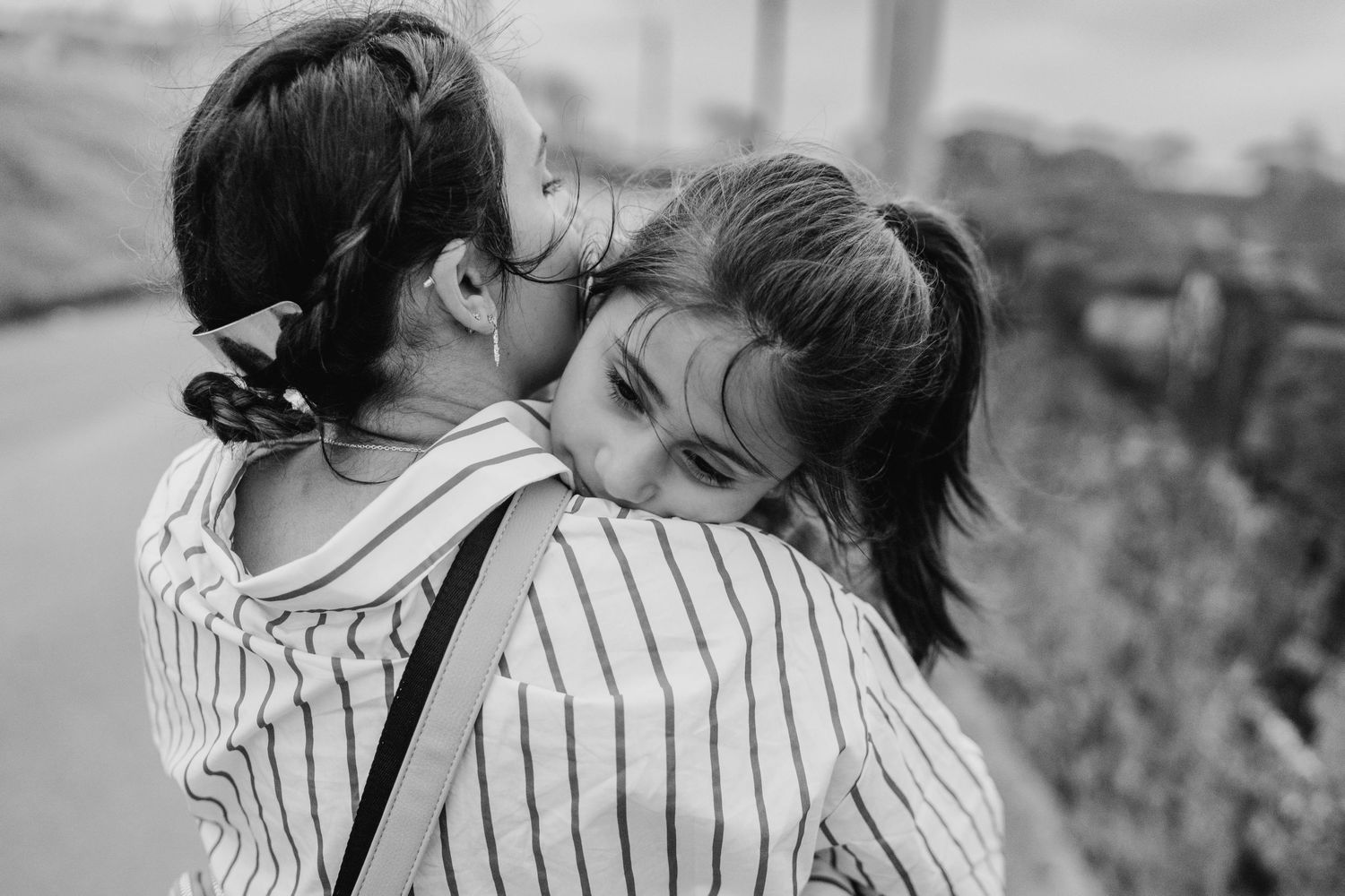 A romantic couple in striped shirts share a tender moment together outdoors during sunset. family PHOTOGRAPHER Dublin