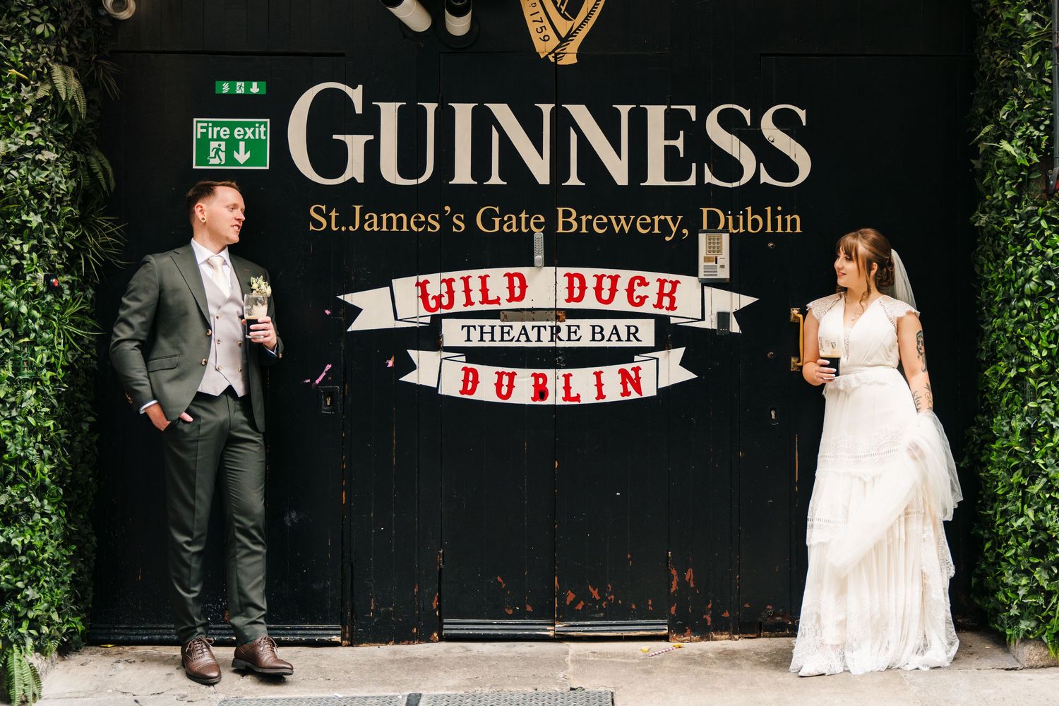 Wedding party poses outside the Guinness Brewery in Dublin with iconic signage visible. Wedding Photographer Dublin Ireland