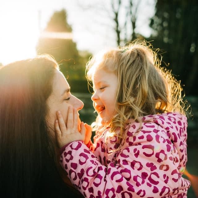A tender moment captured at sunset with a pink leopard print top glowing in warm golden light.deirdre rusk photography - wedding photographe