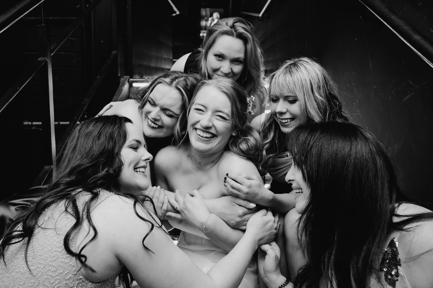 A series of black and white candid photographs showing people embracing and sharing joyful moments. Wedding Photographer Dublin