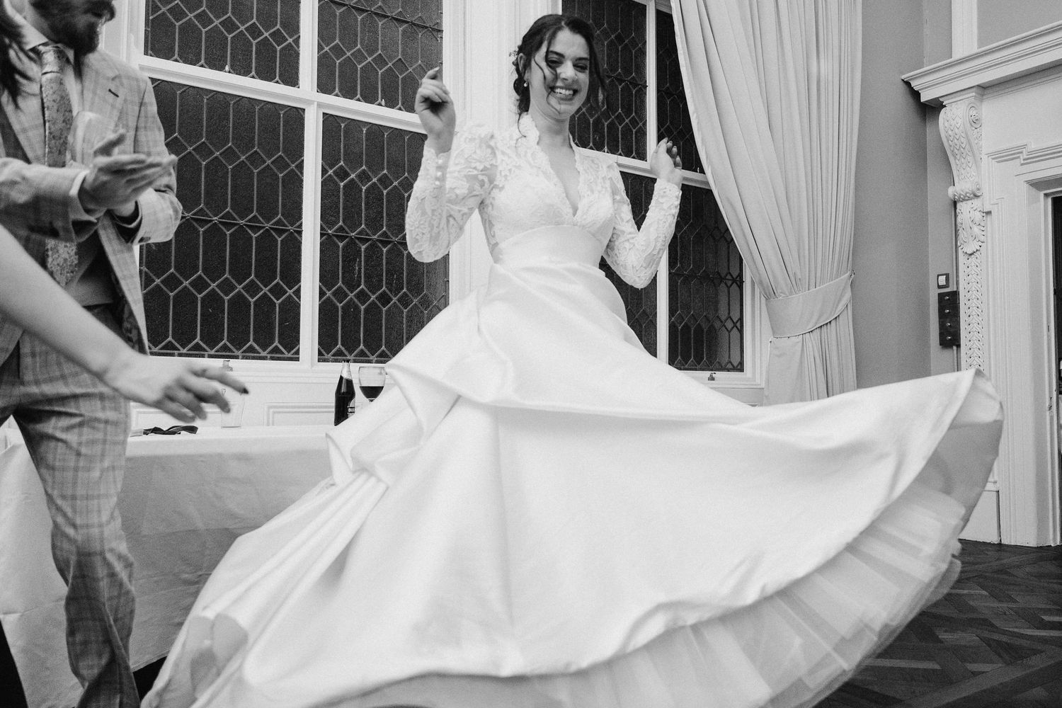 Bride twirls her white wedding dress during reception dance in elegant indoor venue. Stephens green club dublin Wedding photographer