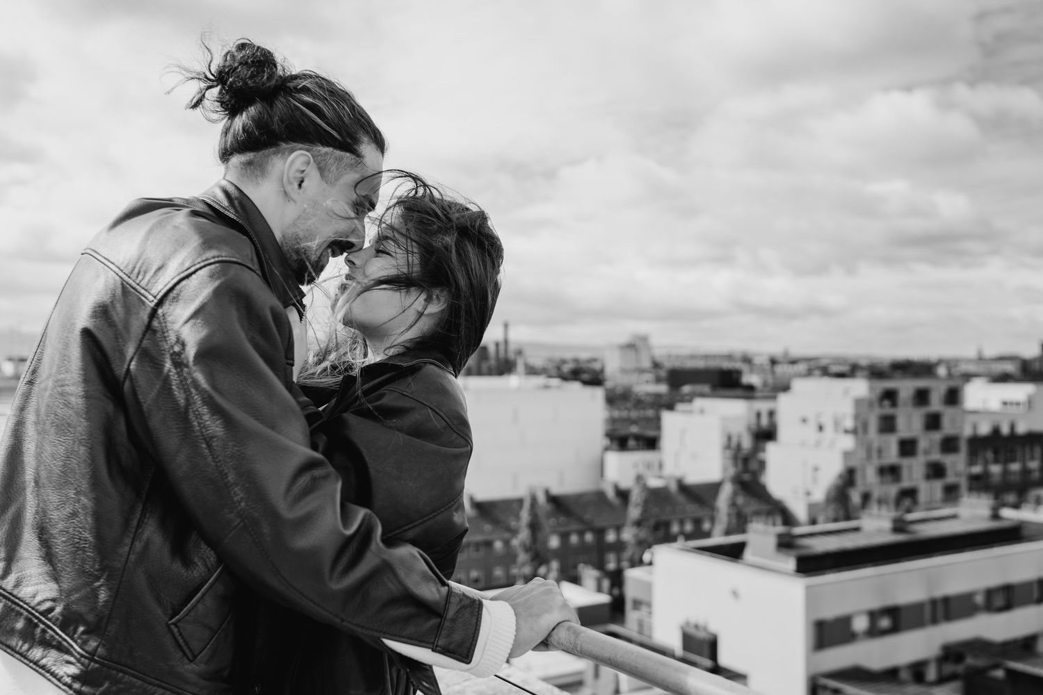 A romantic black and white photo series showing a couple embracing and kissing in various outdoor settings. PHOTOGRAPHER Dublin Meath Cavan