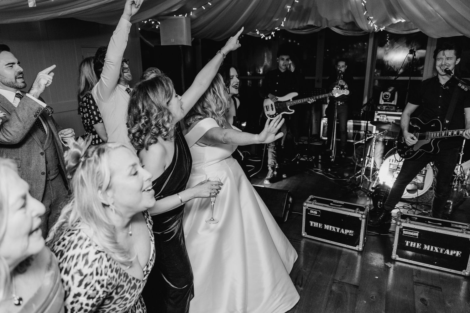 Energetic dance floor scene at wedding reception with band playing in background.  Virginia Park Lodge Wedding Photographer Cavan Dublin Ire