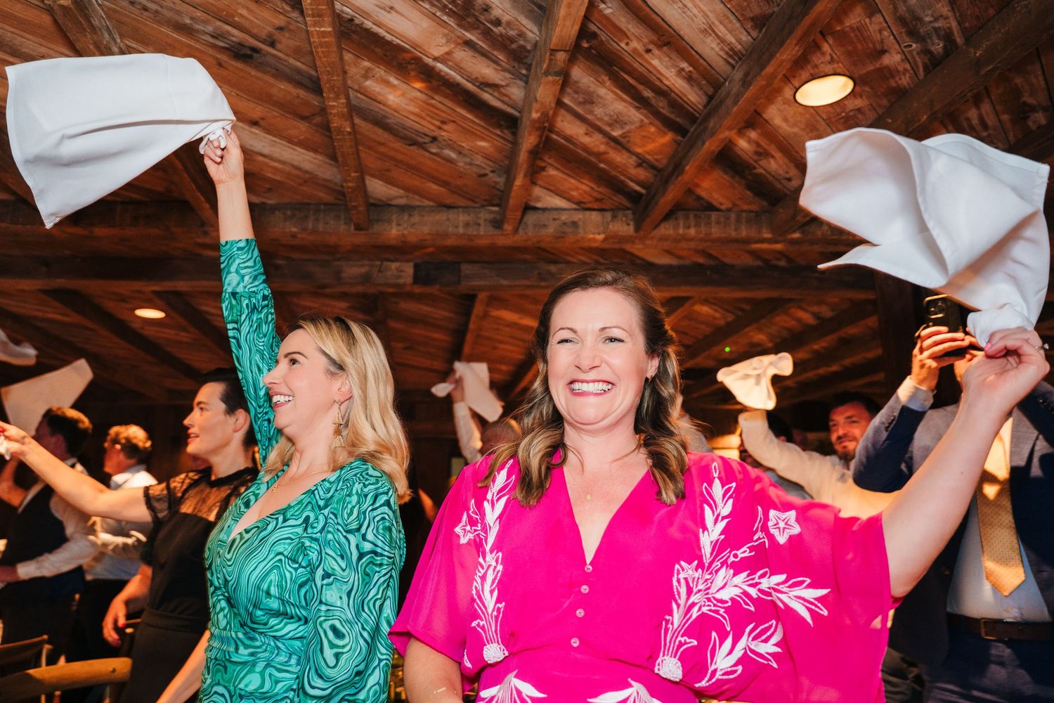 Wedding celebration showing people dancing and having fun under rustic wooden beamed ceiling.  The Dean Dublin Wedding Photographer