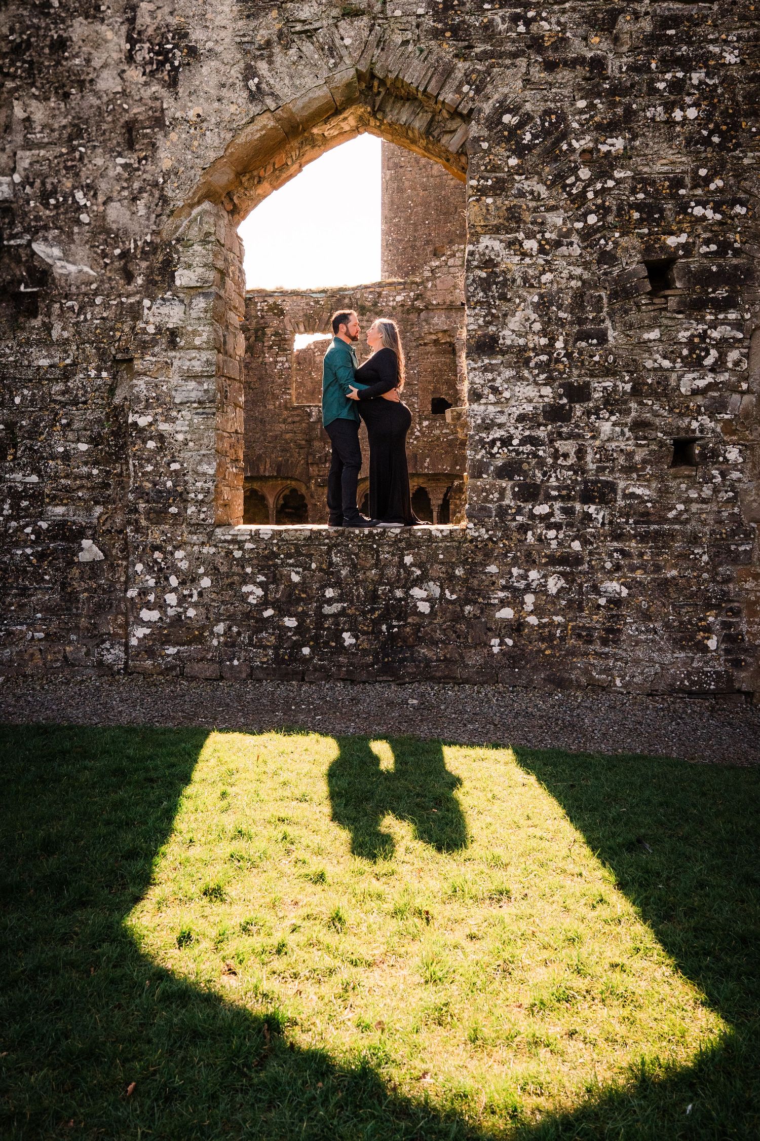 A progression of shadows cast through a stone archway window onto grassy ground in multiple frames. Family PHOTOGRAPHER Dublin