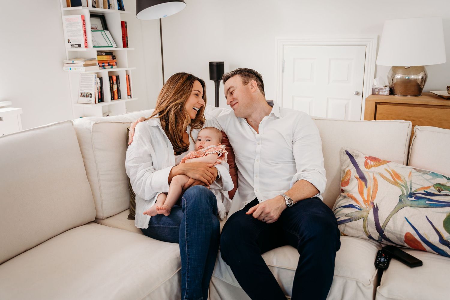 Couple lounging together in a cozy living room setting during an intimate lifestyle photography session. Family PHOTOGRAPHER Dublin
