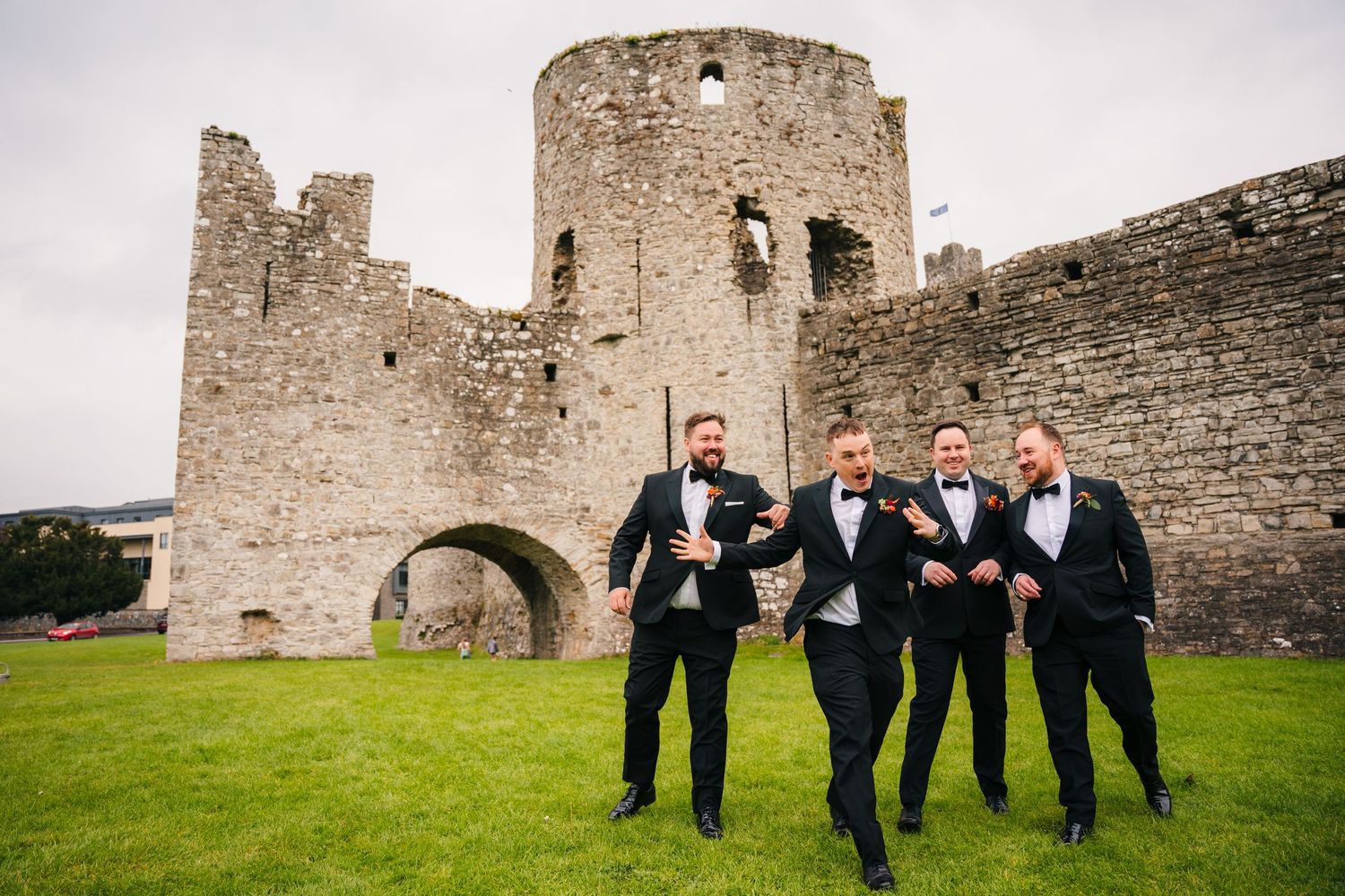 Wedding party having fun posing in front of ancient castle ruins. Wedding Photography Trim Castle Ireland