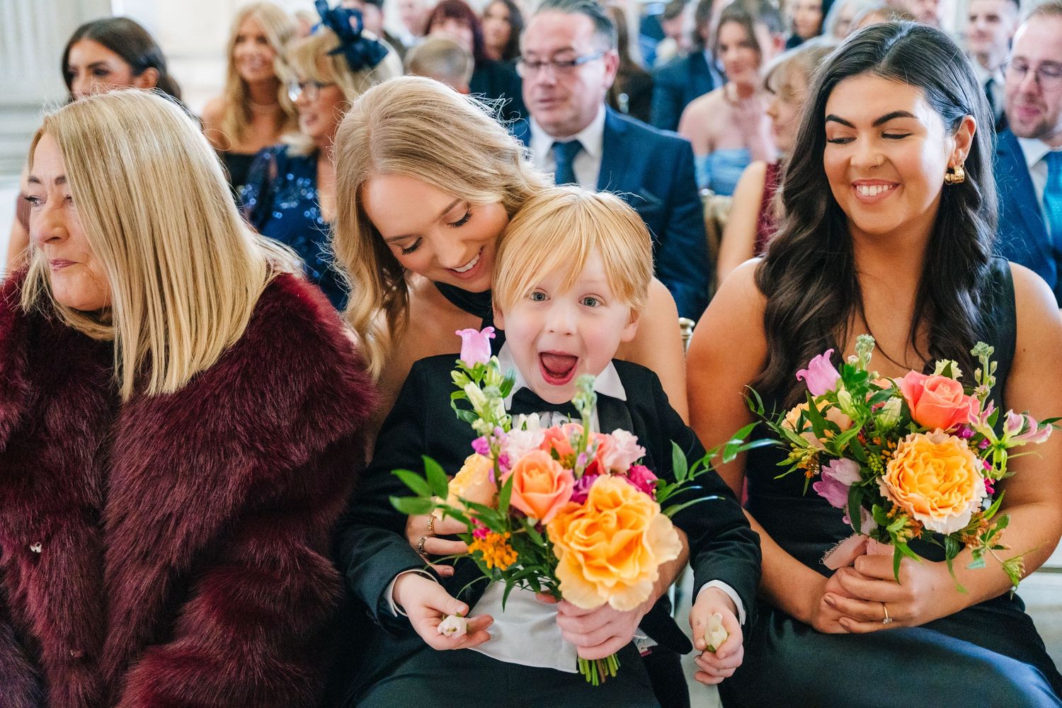 Wedding guests smile and react emotionally during an indoor ceremony. City Hall Dublin Photographer