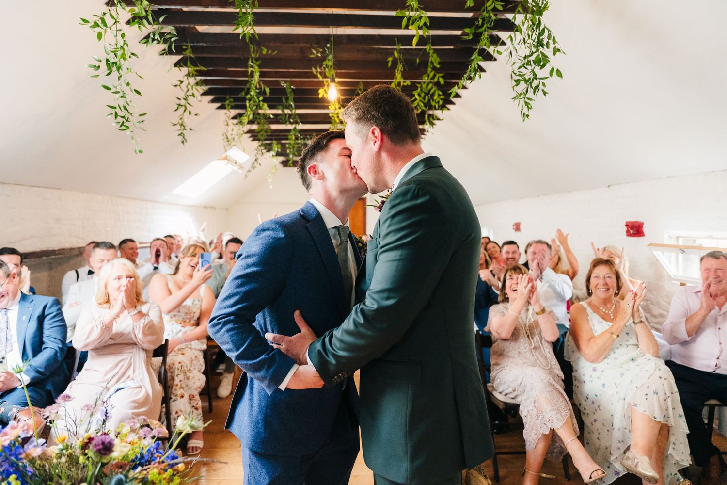 Celebration with dancing and festivities in bright indoor venue. Same sex wedding PHOTOGRAPHER Dublin