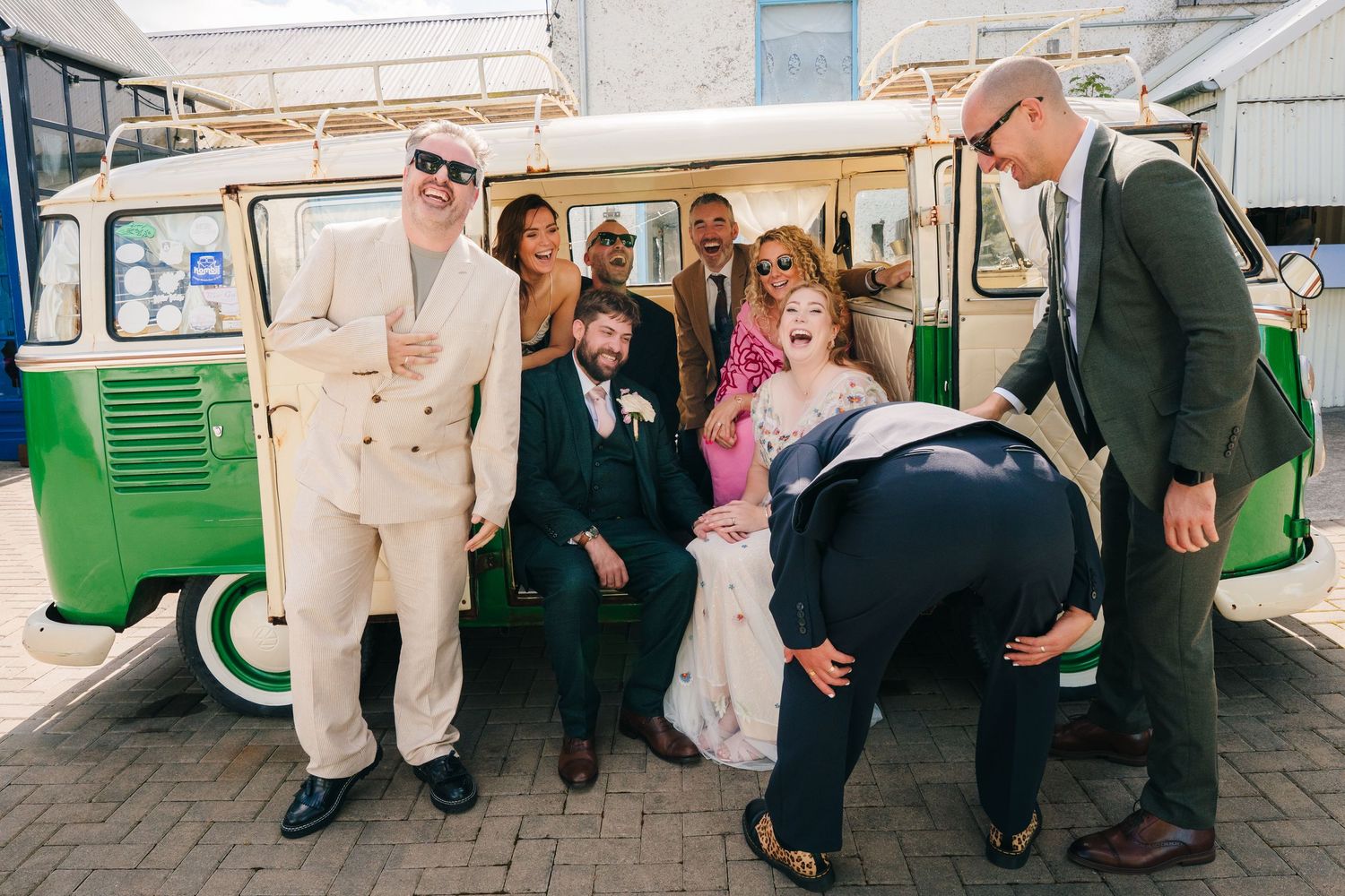 A group gathers around a vintage green and white van for a fun photo moment. . Village Barn Tyrrellspass wedding photographer Ireland