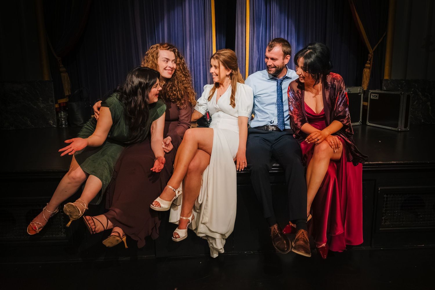 Wedding ceremony at the Set Theatre Langtons Hotel KPeople dancing and having fun at a dimly lit party or nightclub with dramatic lighting.