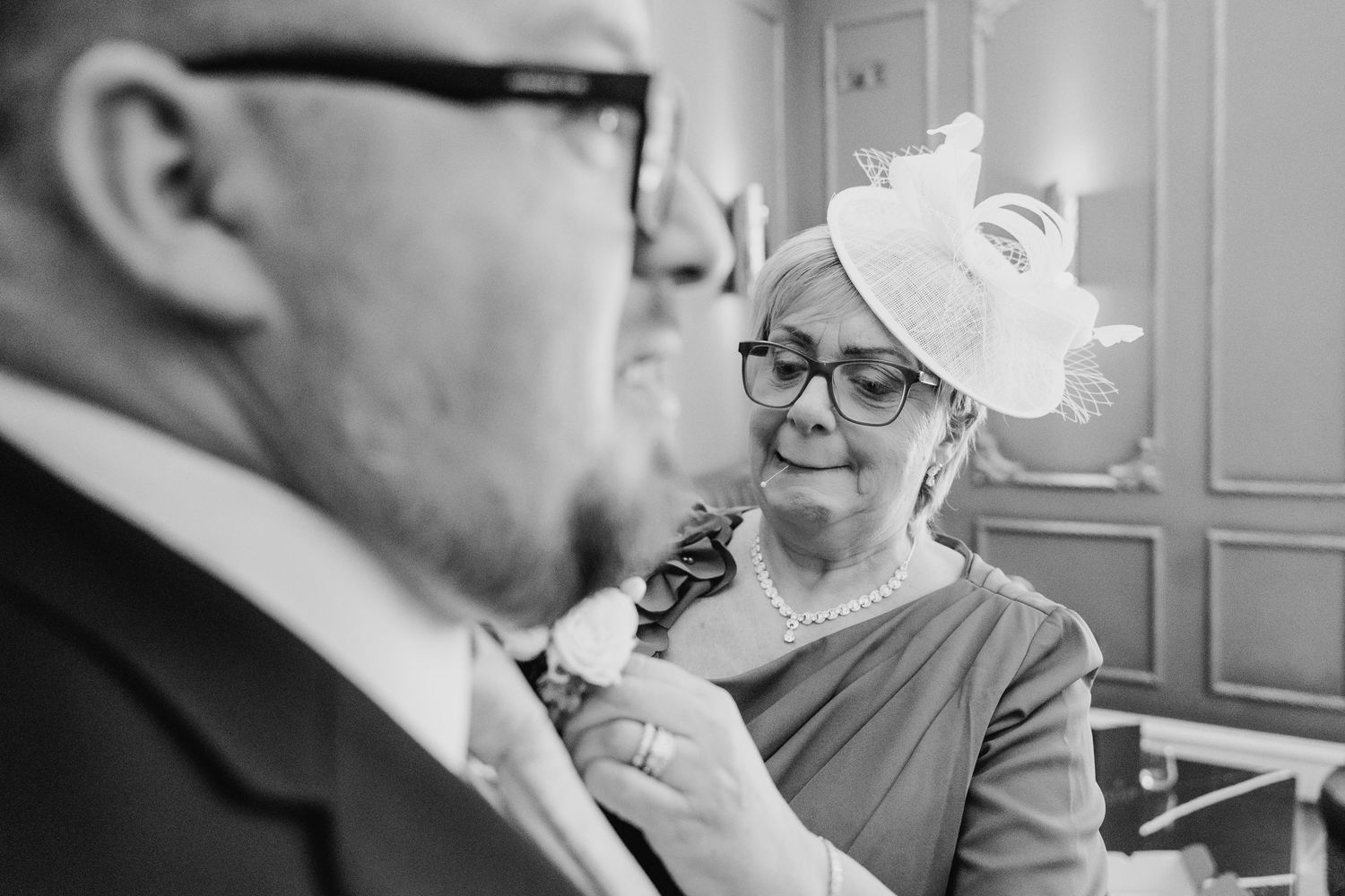 Two elderly people in formal attire share a tender moment while dancing together at an event. Dublin wedding photogrAPher Bewleys Grafton