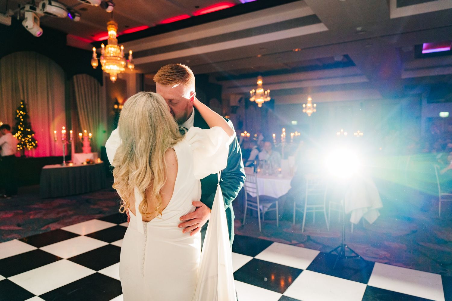 Wedding reception dance floor with checkered pattern and dramatic lighting effects. Wedding photographer dublin