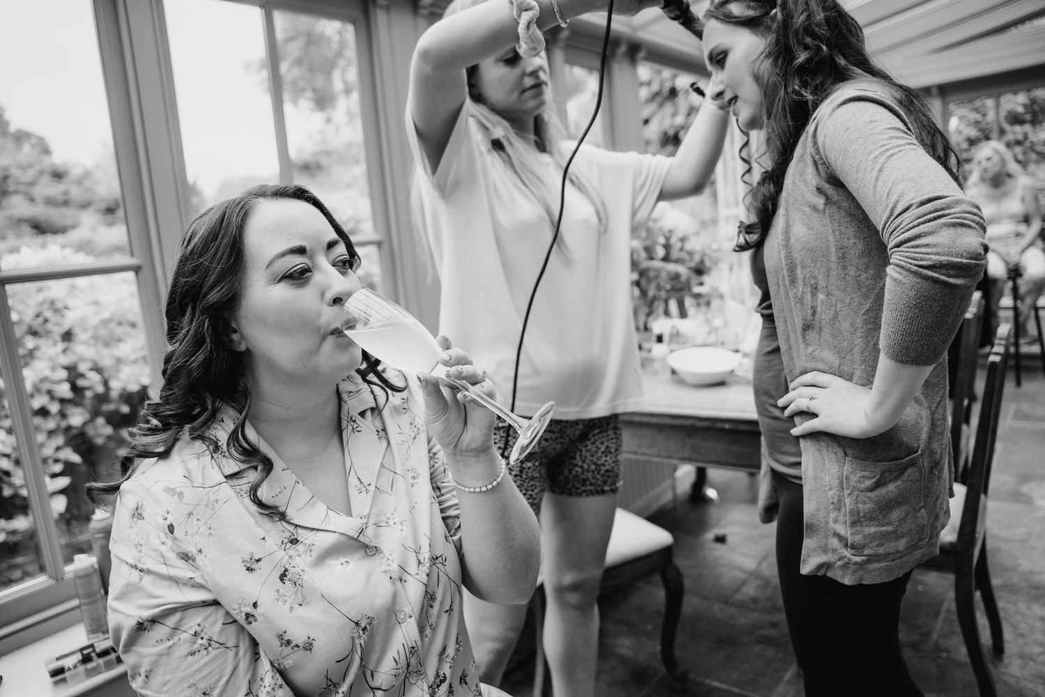 Wedding guests sharing joyful laughter and candid moments during an outdoor celebration. Wedding photographer Dublin