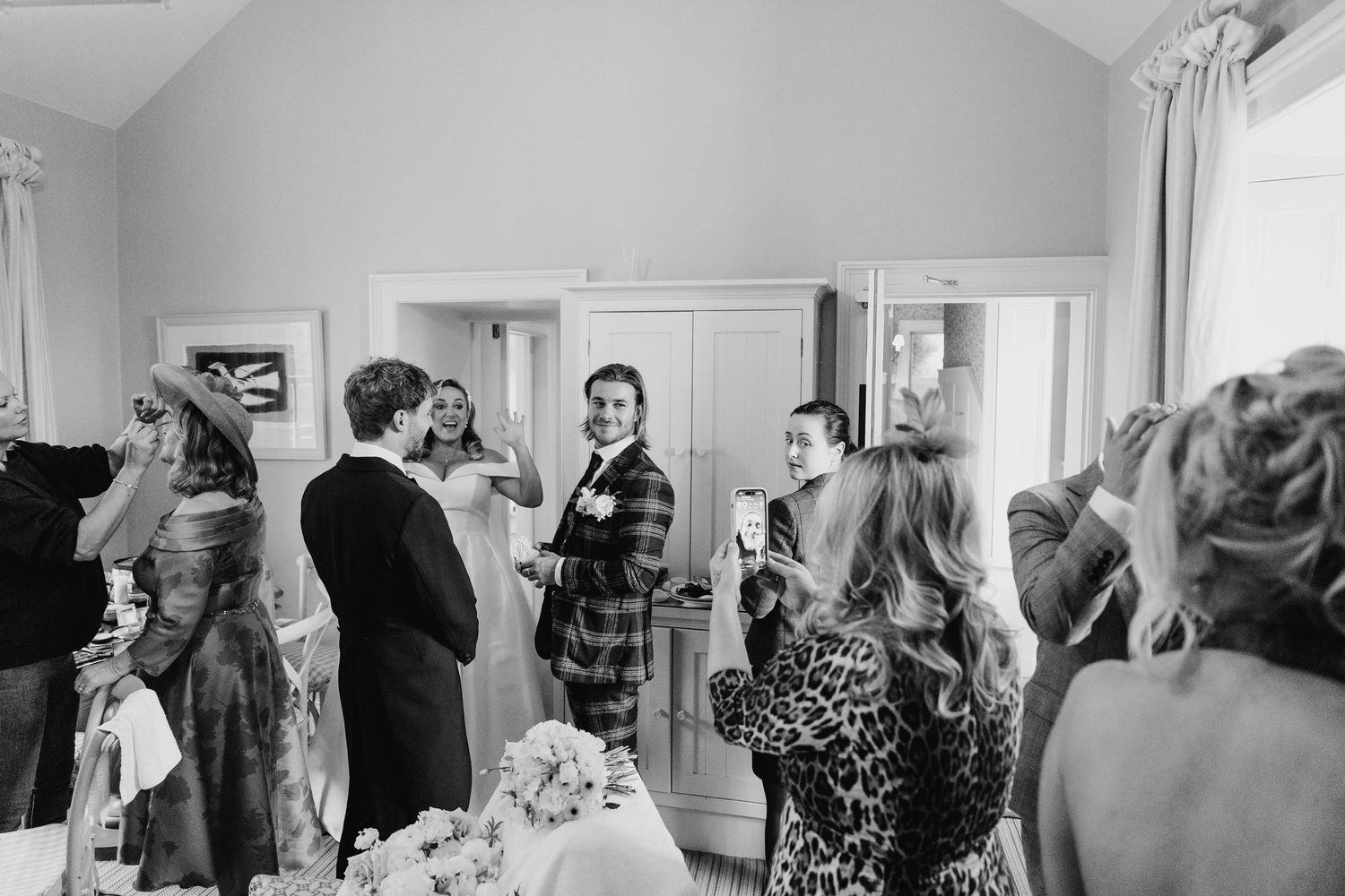 Wedding guests mingle and socialize in a bright indoor space during pre-ceremony preparations.  Virginia Park Lodge Wedding Photographer Cav