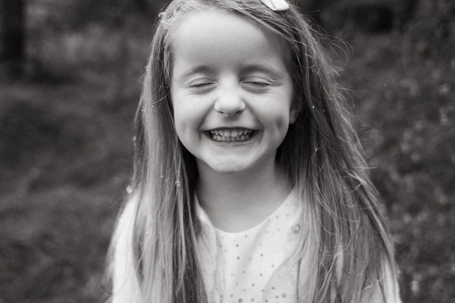 Black and white portrait series showing joyful expressions and genuine smiles.