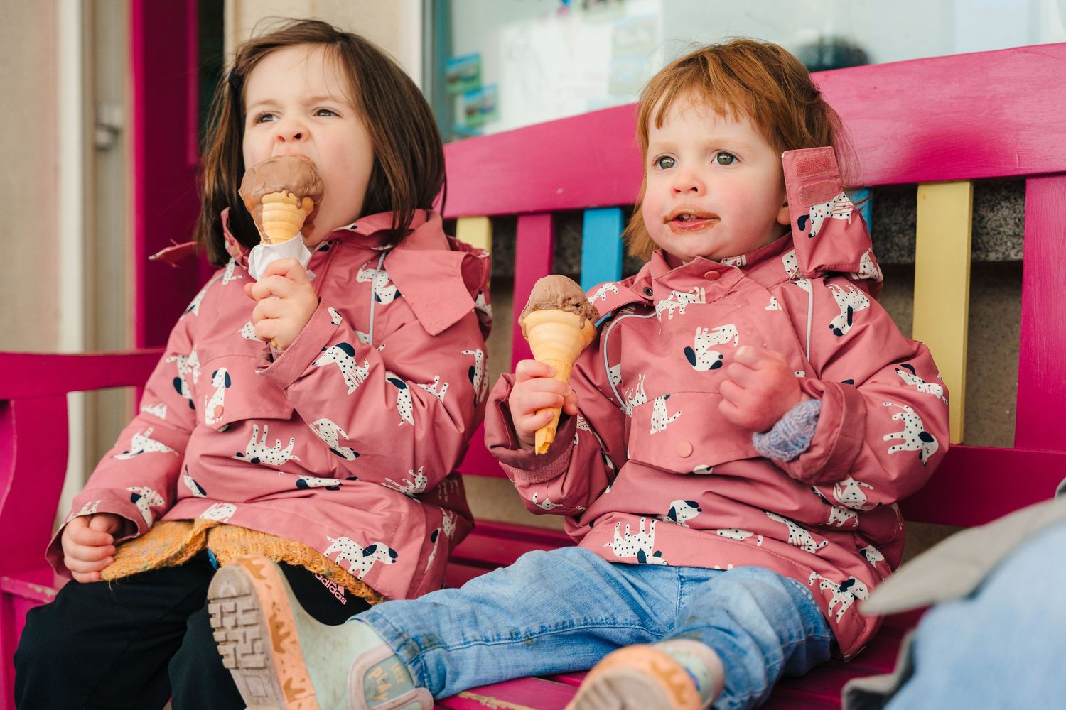 Children in matching pink sweaters sitting together enjoying ice cream. PHOTOGRAPHER Dublin