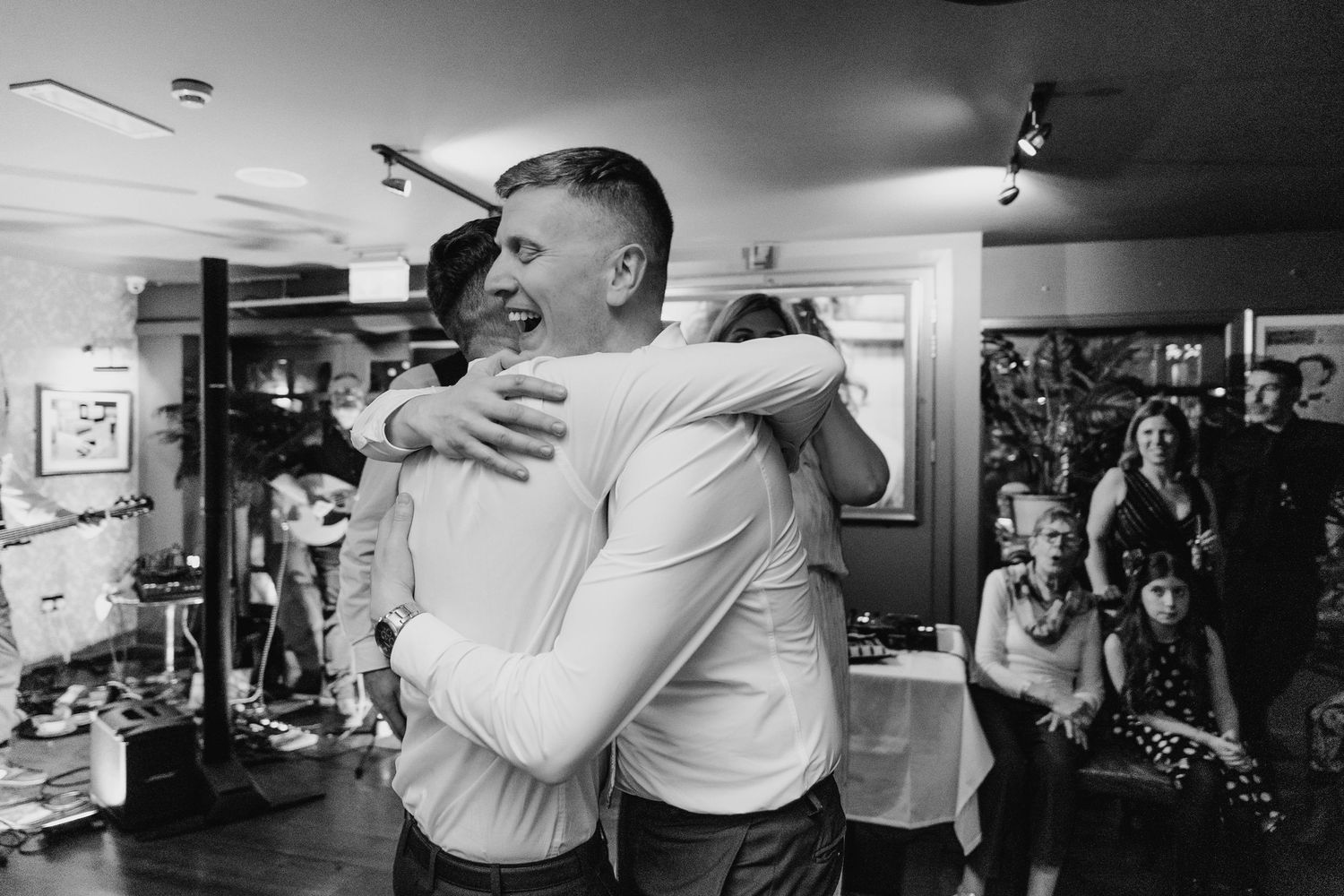 Black and white photo sequence showing candid moments between guests dancing at a wedding reception. Marco Pierre Dublin Wedding Photographe