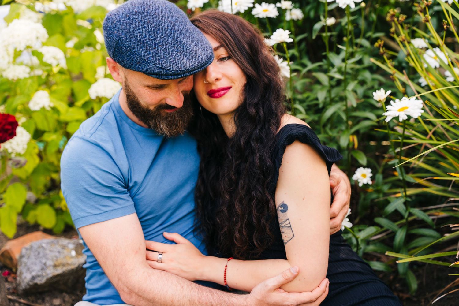 Intimate couple embraces in lush garden setting surrounded by green foliage. PHOTOGRAPHER Dublin ireland