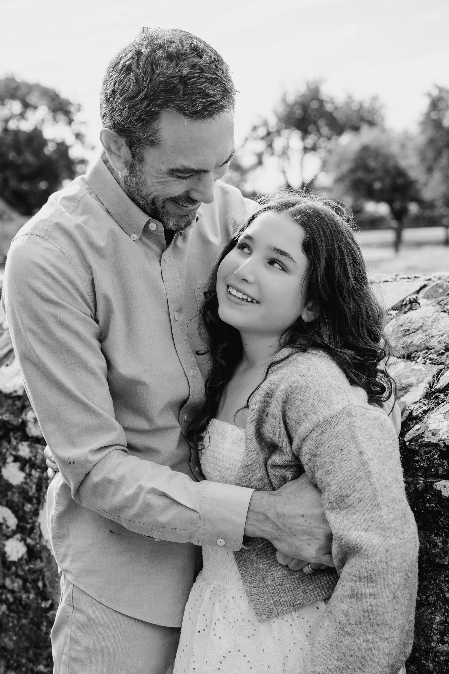 A romantic black and white photo series showing tender moments between a couple in casual attire outdoors. BEctive abbey family photographer