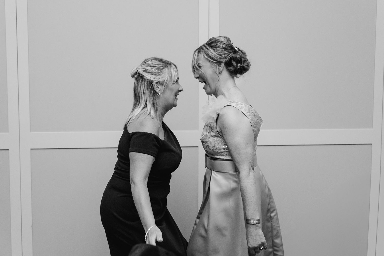 Black and white candid shots of wedding guests interacting at a formal event. Wedding photographer dublin