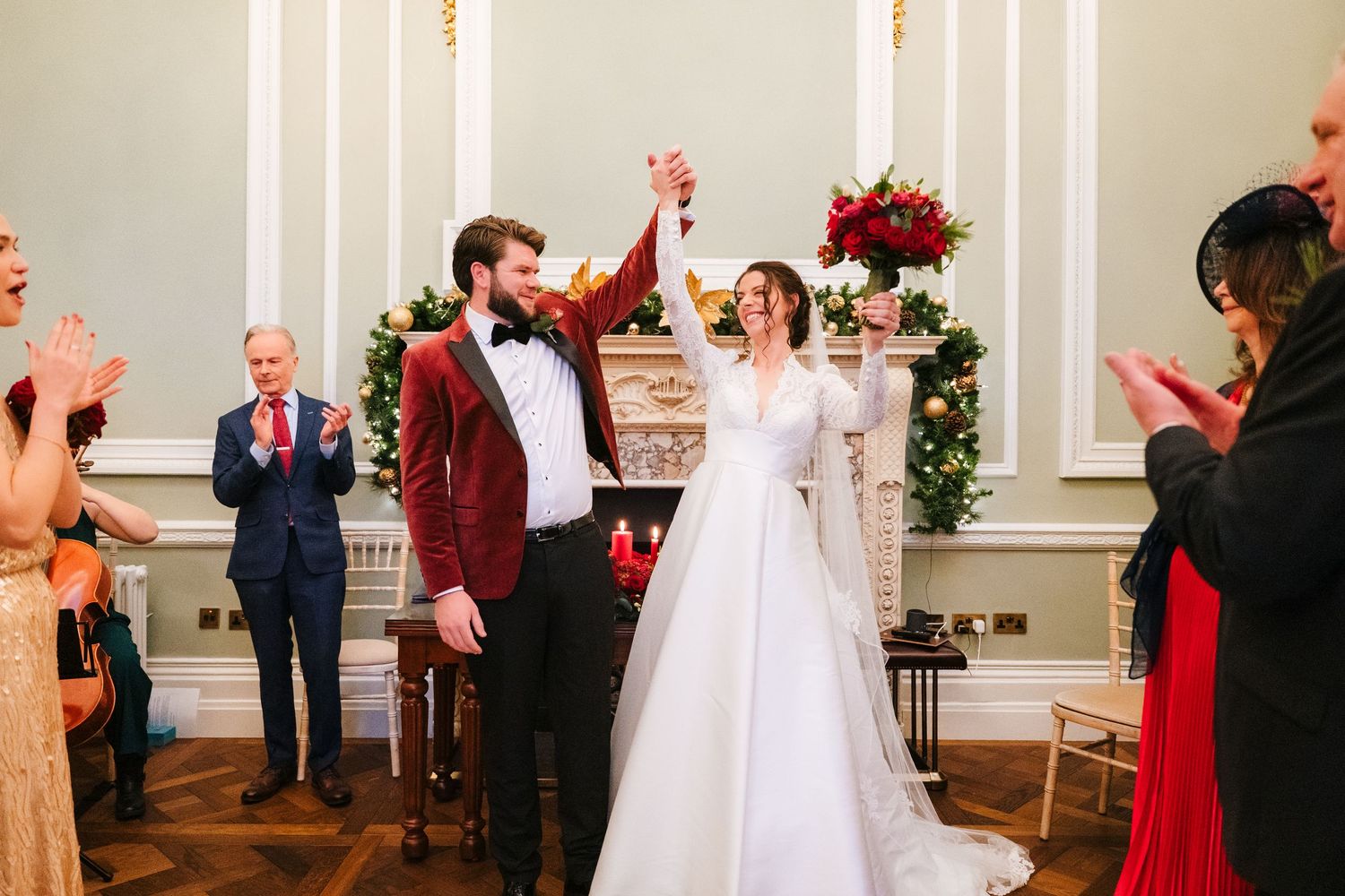 Wedding party celebrates joyfully in an elegant indoor venue with decorative lighting Stephens green club dublin Wedding photographer