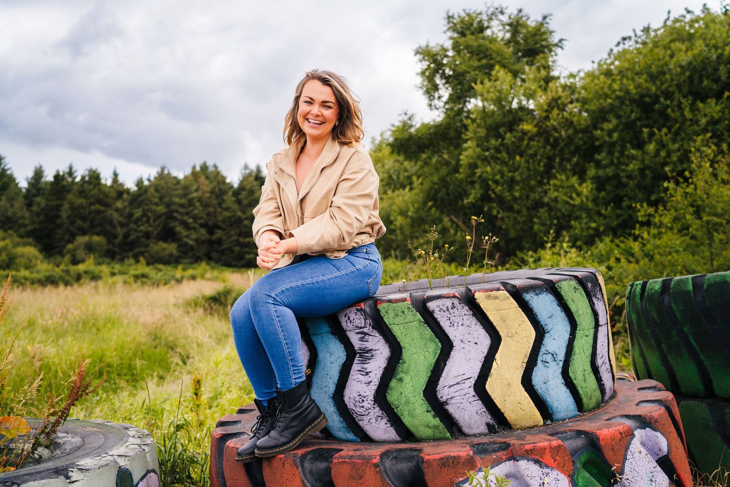 Colorful socks displayed in a row on a rustic wooden bench in an outdoor garden setting. Professional headshots PHOTOGRAPHER Dublin