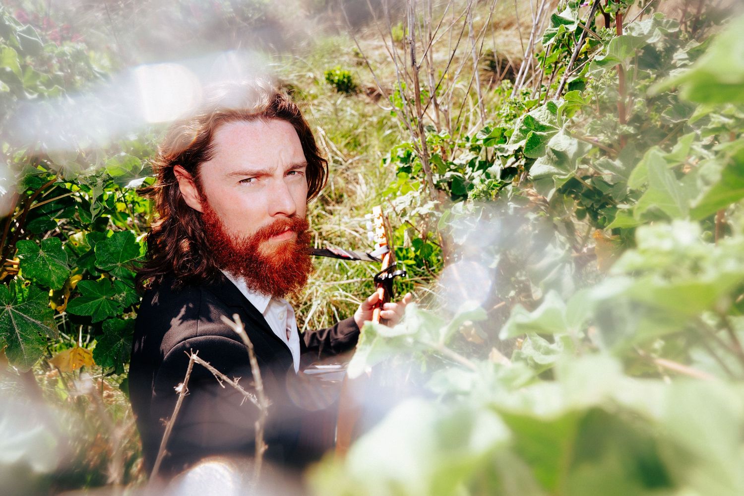 Dreamy portrait through foliage with soft natural light and mist effects. PHOTOGRAPHER Dublin
