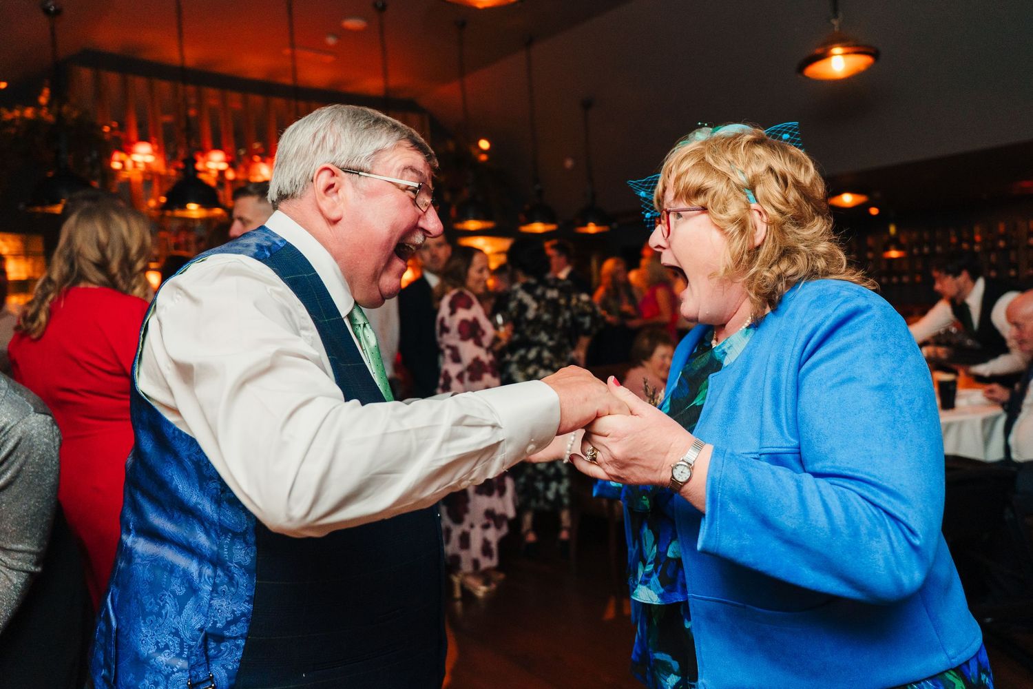 Energetic couples dancing at a dimly lit wedding reception party. Marco Pierre Dublin Wedding Photographer