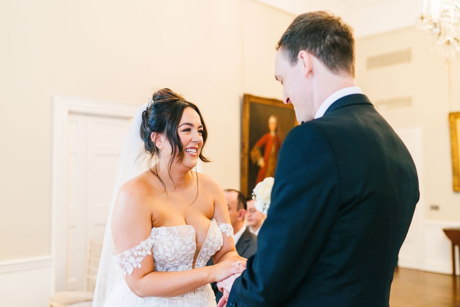 Intimate wedding ceremony moment with a couple exchanging vows in an elegant indoor setting.  Wedding PHOTOGRAPHER Dublin