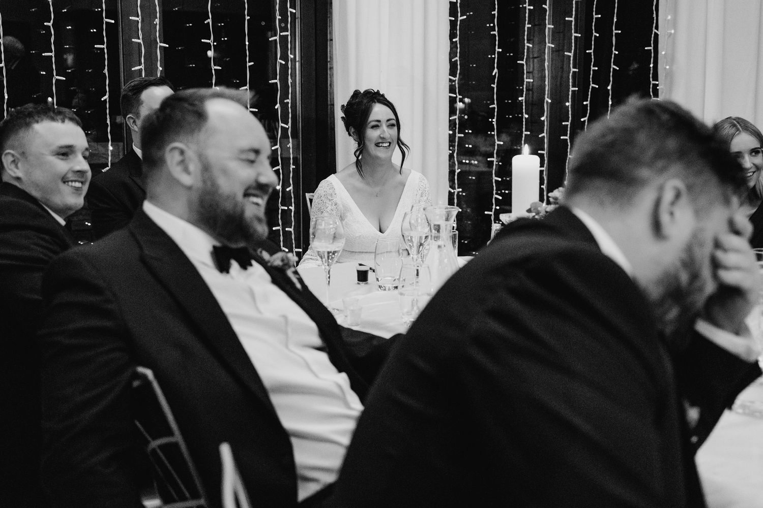 Wedding reception with string light backdrop and guests enjoying the celebration.Wedding Photography Trim Castle Ireland