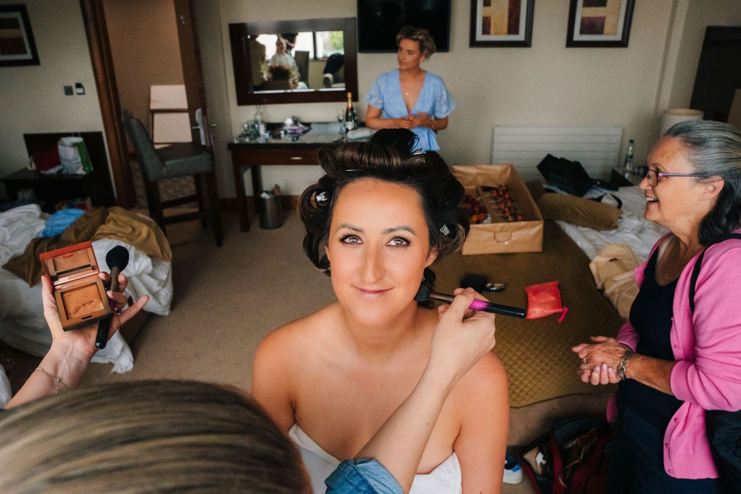 Group getting ready for wedding day in bright sunlit room with casual atmosphere. Wedding Photography Trim Castle Ireland