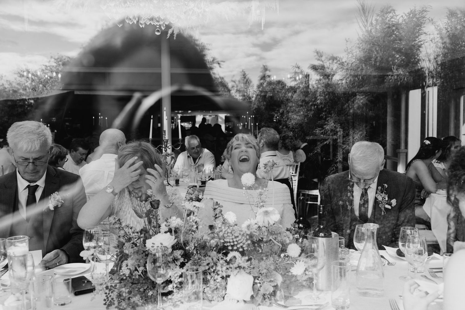Millhouse slane wedding photographer dublA black and white panoramic view of wedding guests seated at tables during a reception celebration.
