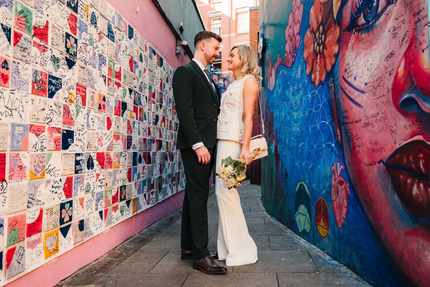 Colorful street art mural wall creates vibrant backdrop for urban photography session. City Hall Dublin wedding photogrAPher