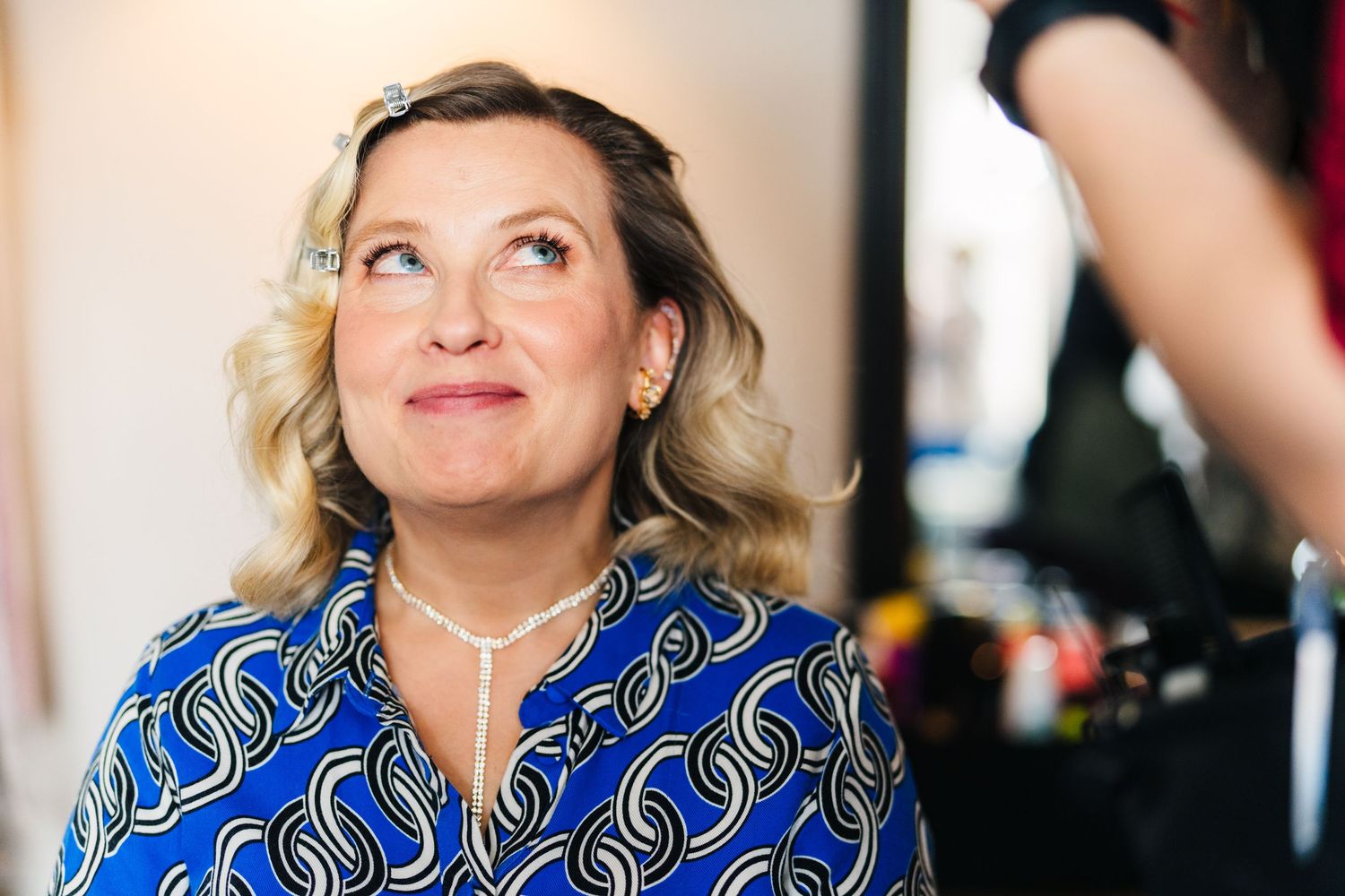 A person in a vibrant blue patterned top smiles during a social gathering. House Dublin Wedding Photographer