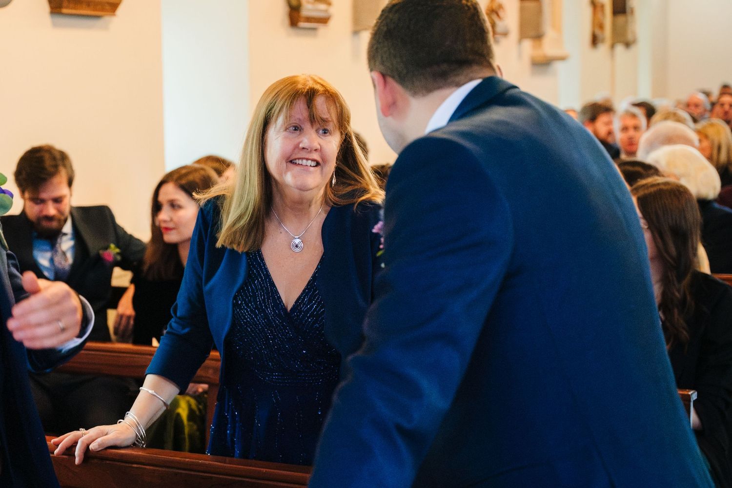 Guests enjoying themselves during an indoor wedding reception celebration.